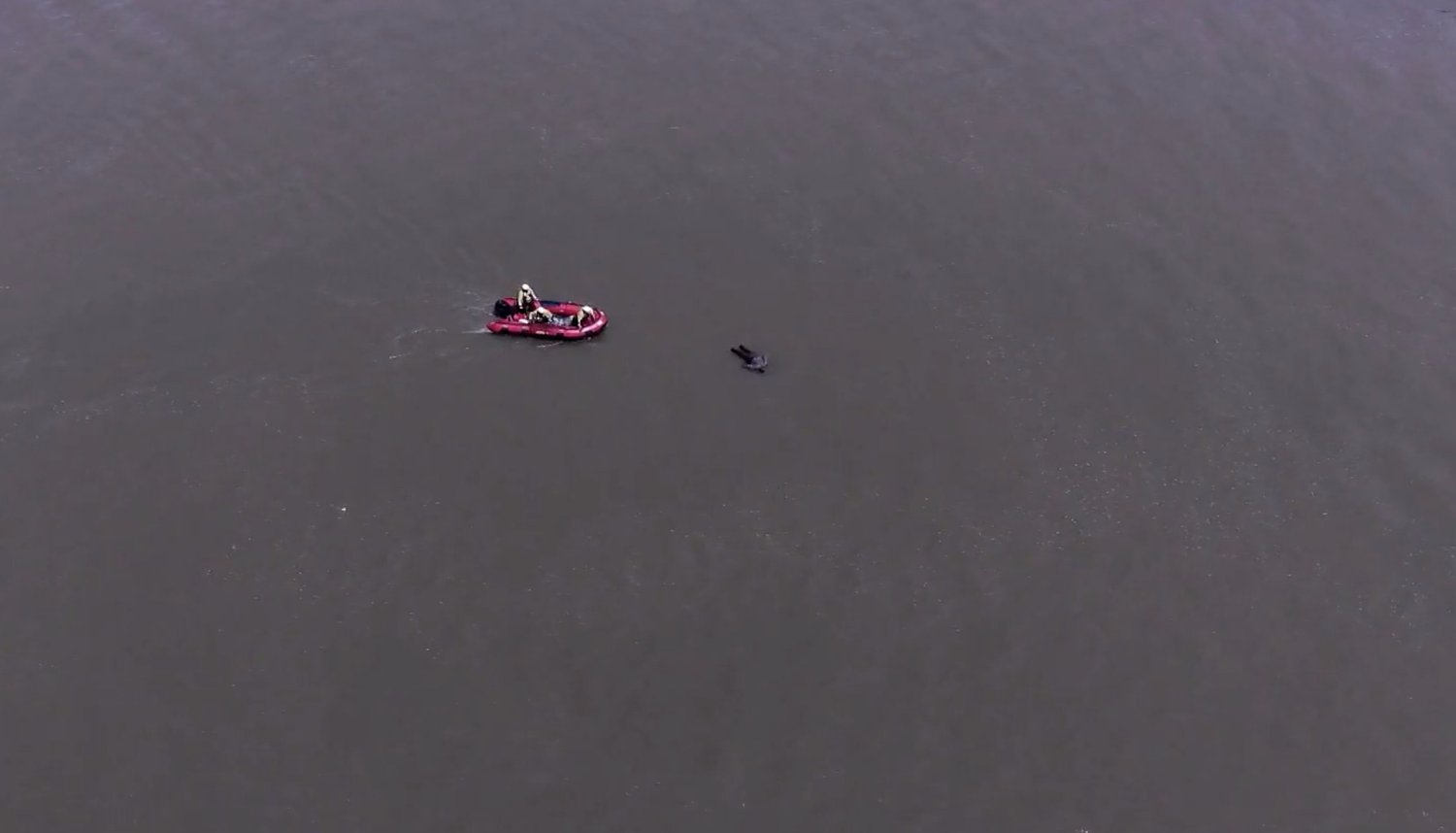 Aerial view of a dive team working a water recovery from an inflatable boat